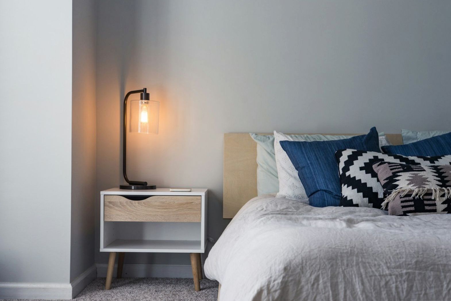 Sunlit hotel bedroom with linen bedding and warm sandstone tones