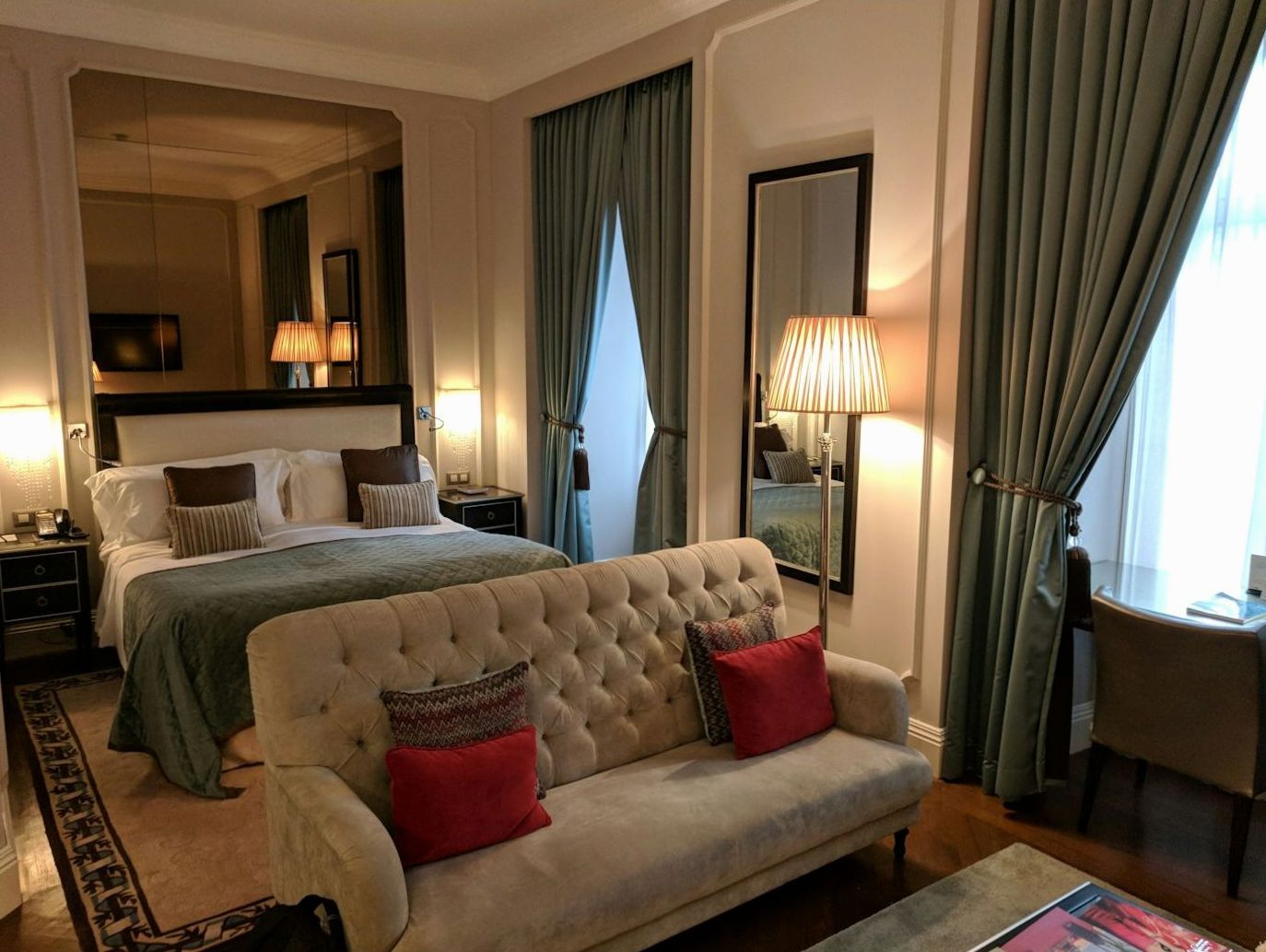 Deluxe hotel room with seating nook and warm taupe finishes